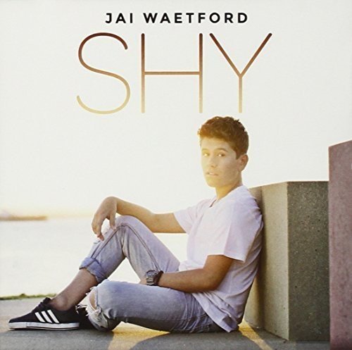 "Album cover featuring a young man sitting on the ground against a concrete wall."
