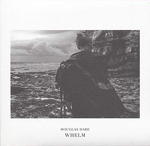Black and white album cover with a man overlooking a seascape.
