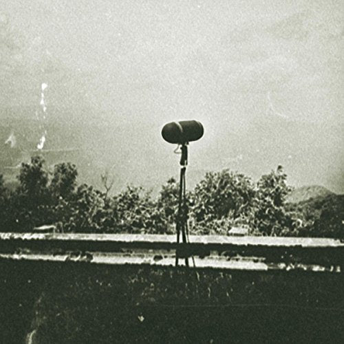 Grainy black and white photo of a shortwave radio antenna on a rooftop.