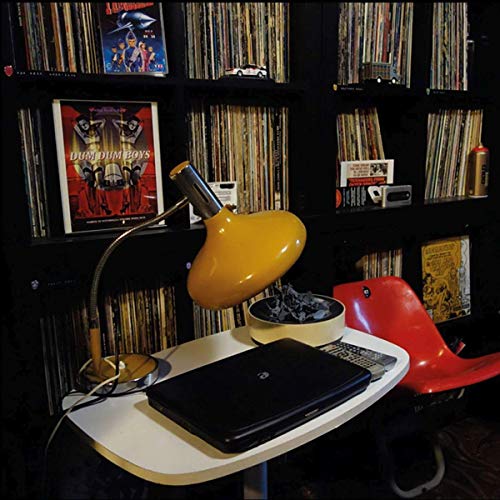 "Dum Dum Boys vinyl record album cover displayed on a shelf with other records."
