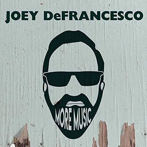 Album cover for Joey DeFrancesco’s “More Music” with a portrait and text.