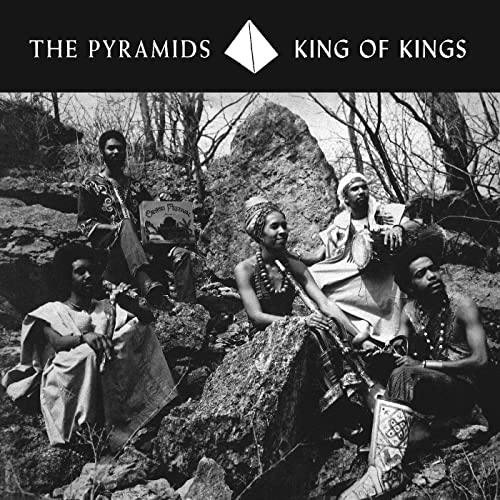 Black and white album cover featuring a group of people outdoors.