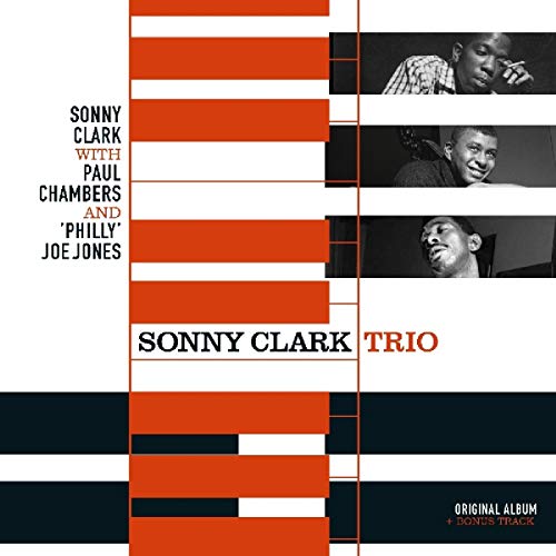 "Album cover with orange, white, and black design, featuring three black-and-white musician portraits."