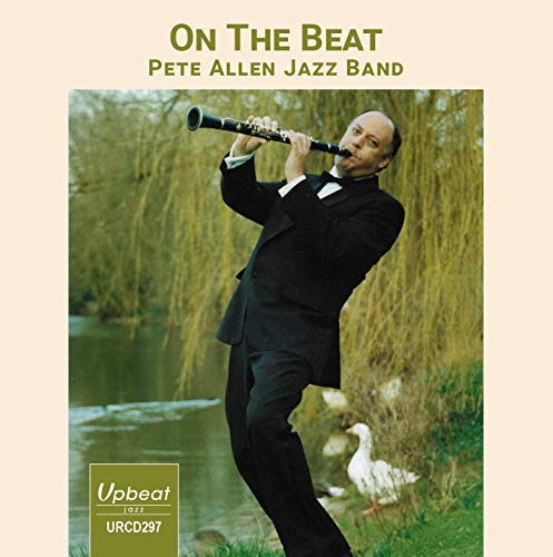 Album cover with man in black suit playing clarinet outdoors beside a pond.