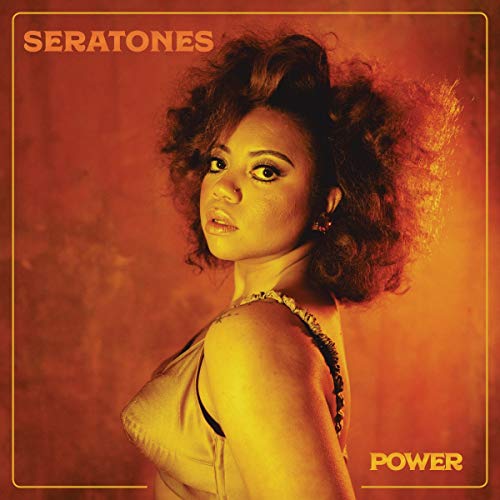 Album cover with a woman in a white top, orange background, and yellow text.