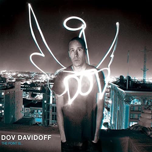 CD cover: Man with glowing lines resembling wings, city background.
