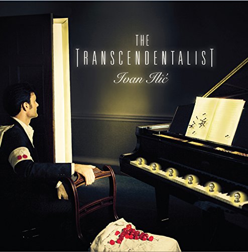 Man in a black jacket sits at a grand piano, with red roses nearby.