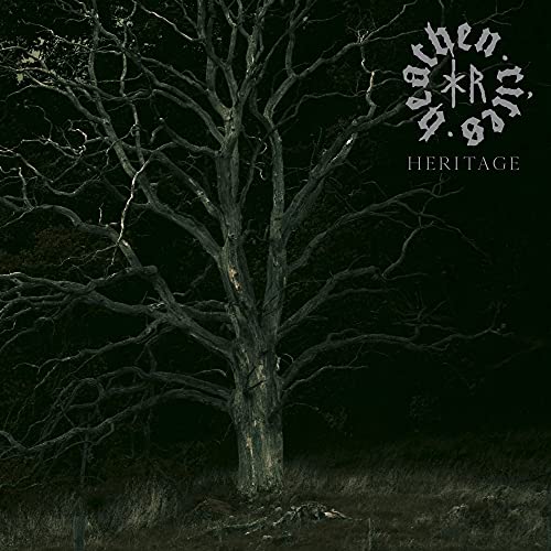 Dark album cover featuring a bare tree against a shadowy, muted background.