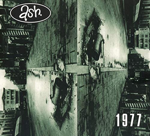 "Album cover with black and white cityscape, damaged wall, and 'ash' logo."