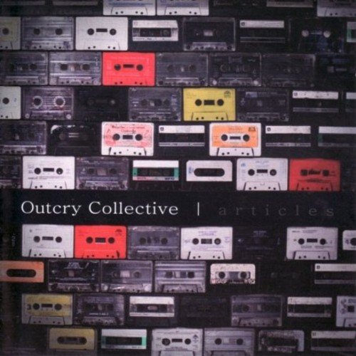 "Album cover featuring a wall of cassette tapes with some colored inserts."
