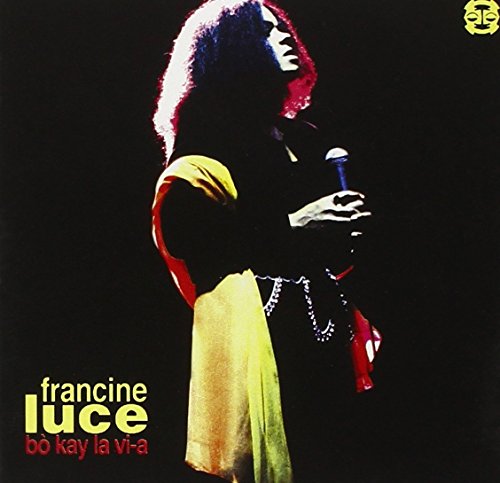 "Album cover featuring a silhouette of a woman holding a microphone against a black background."