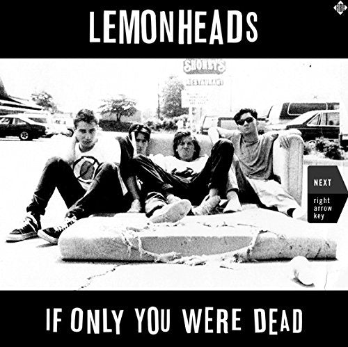 Black and white photo of The Lemonheads sitting on a mattress in a parking lot.