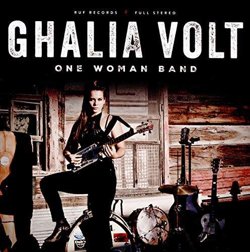 CD cover featuring a woman playing guitar with drums and other instruments.