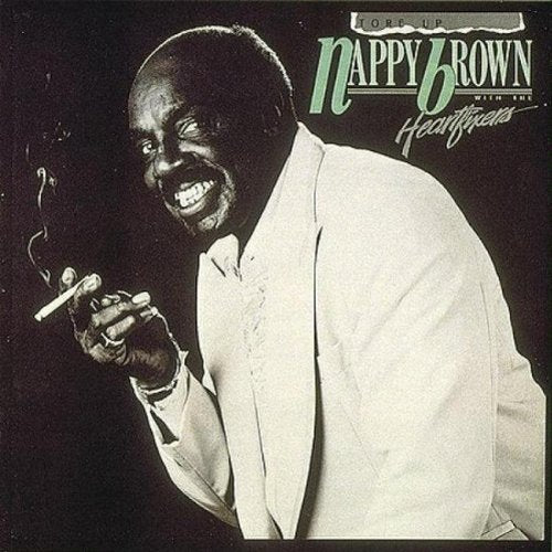 Album cover with a black man in a white suit holding a cigarette.