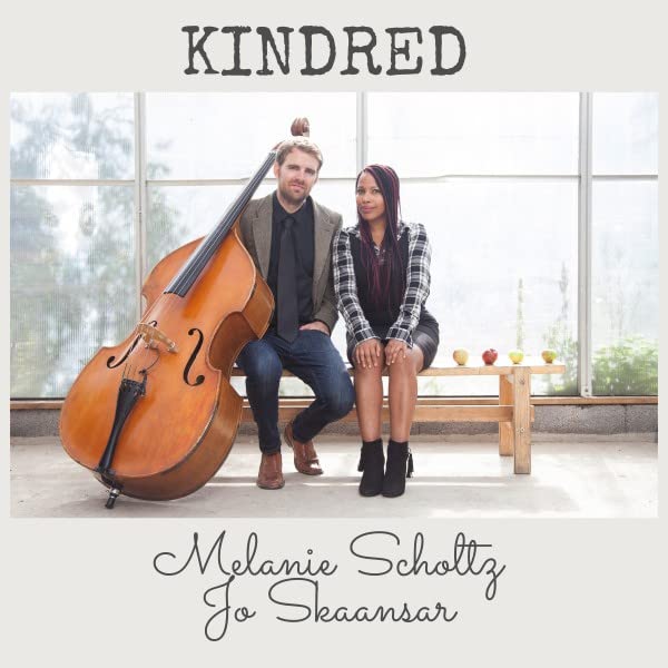 CD cover featuring a man with a cello and a woman seated on a bench.