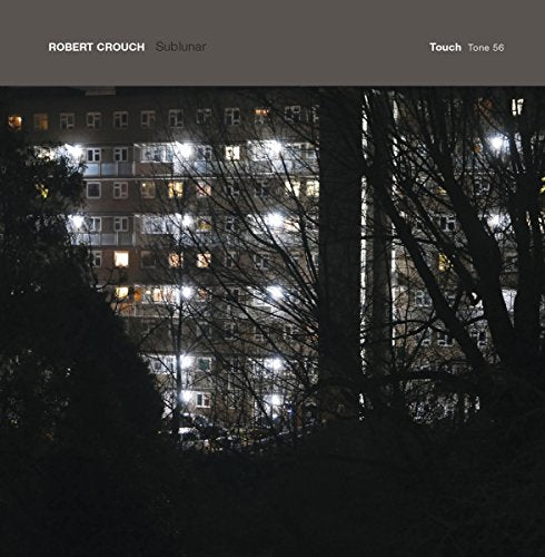 CD cover: Nighttime cityscape with illuminated apartment building and silhouetted trees.