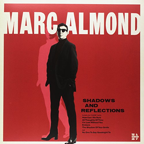 Red album cover with man in black clothing and sunglasses, shadow behind him.