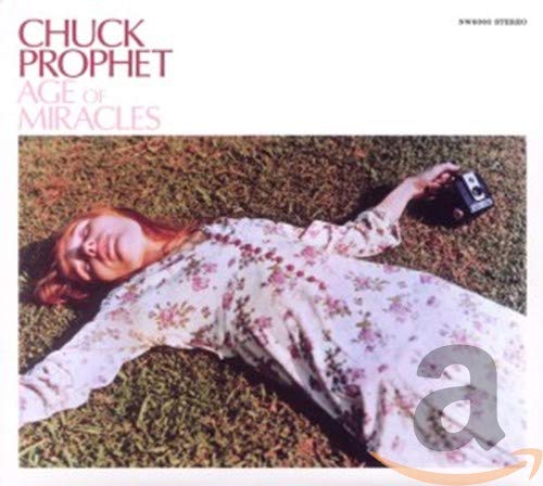 Album cover: woman lying in grass with a vintage camera.