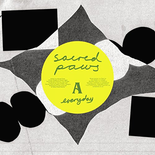 Yellow vinyl record with black and white abstract shapes.