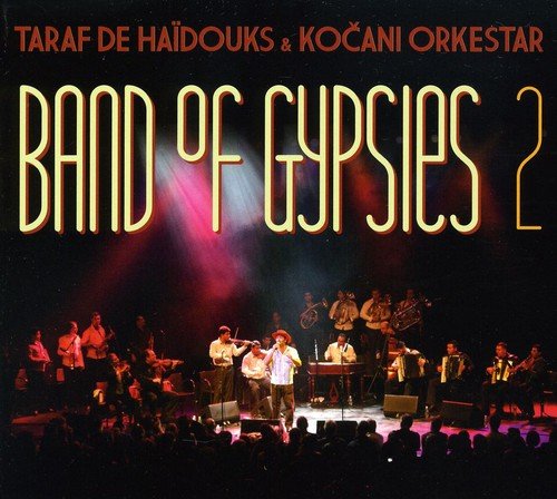 "CD cover with a band performing on stage under spotlights, surrounded by an audience."