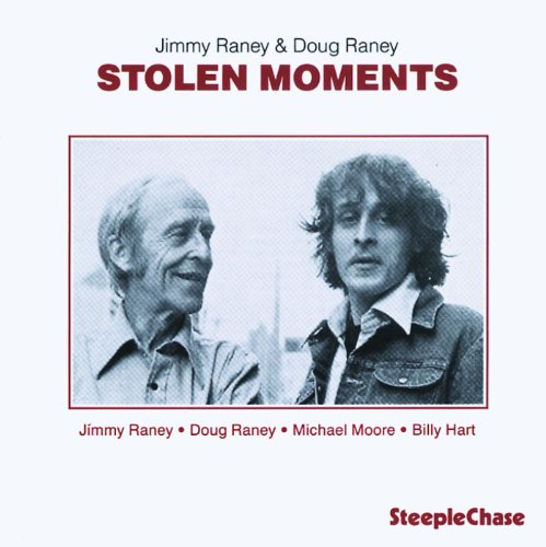 "Album cover with black and white photo of two men, red text on white background."
