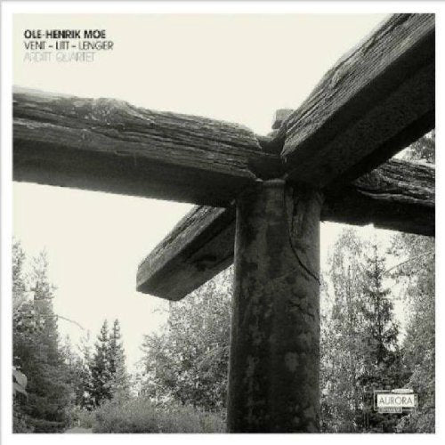 "Black and white CD cover with wooden structure and trees in the background."