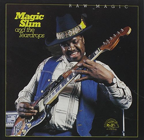 "Album cover featuring Magic Slim playing guitar, wearing a hat and denim vest."