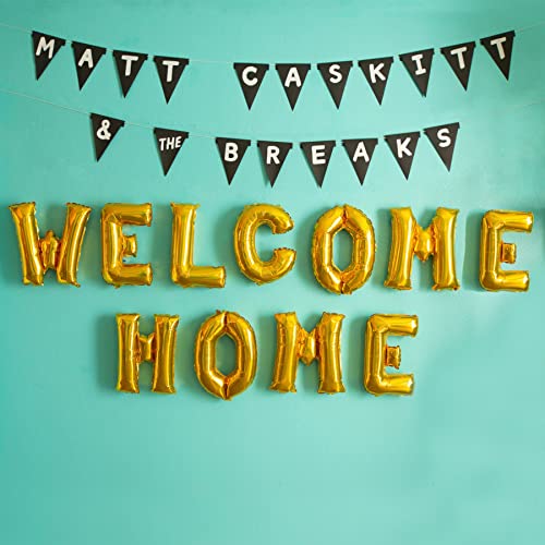 Gold foil letters spelling "Welcome Home" with black banner flags.