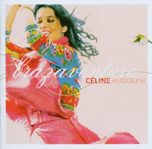 "Album cover featuring a woman in a colorful outfit dancing against a light pink background."