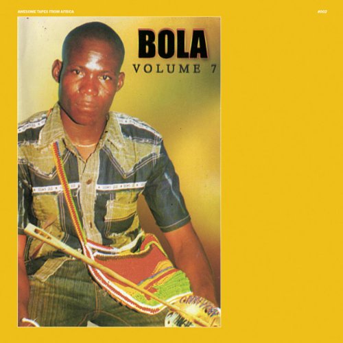 A man in a patterned shirt holds a traditional instrument on a yellow background.