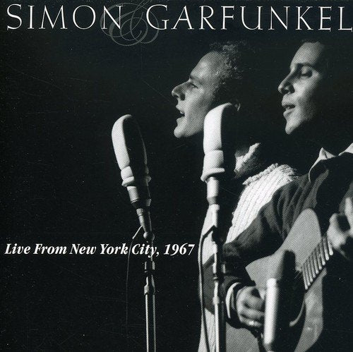 Black and white image of Simon & Garfunkel singing into microphones on a dark background.