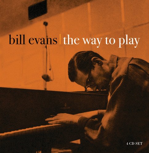 "CD cover with Bill Evans playing piano, sepia-toned image, orange tint."