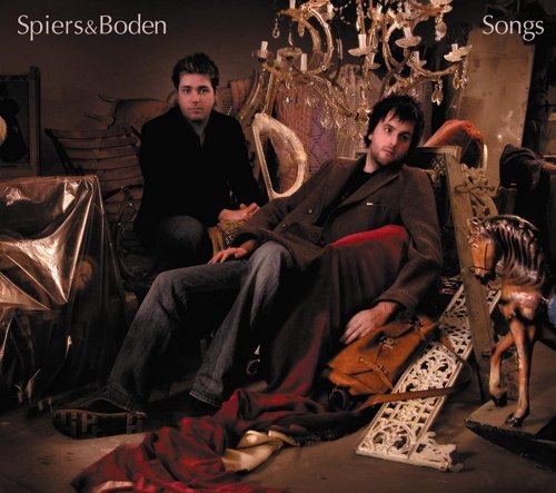 "Album cover with two men sitting amidst cluttered, dimly lit, antique-filled room."