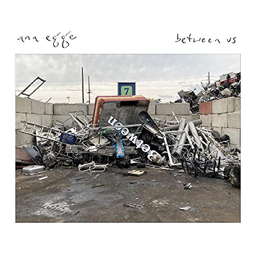CD cover for Ana Egge’s “Between Us” featuring a scrap metal pile.