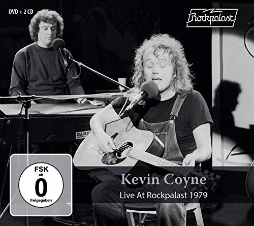 Black and white image of Kevin Coyne performing on stage with another musician.
