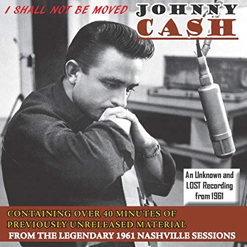 Johnny Cash at a microphone in a recording studio, CD cover.