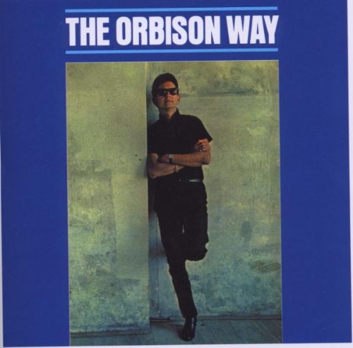 "CD cover with Roy Orbison standing against a wall, wearing sunglasses, on a blue background."