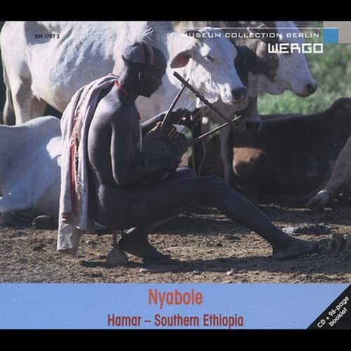 CD cover: Hamar man playing a musical instrument with cattle.
