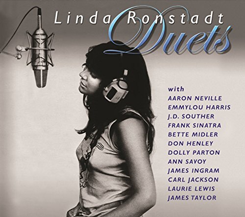 "Linda Ronstadt in headphones, with a microphone, on a gray background, for 'Duets' CD."