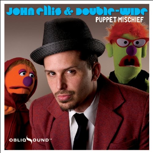 Man in red suit and hat with two puppets beside him on album cover.