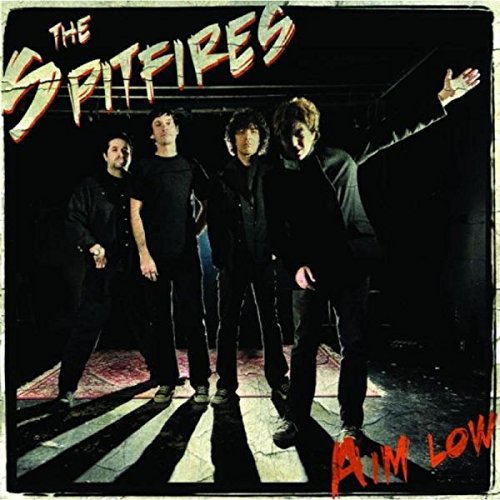 "Album cover with four men in black standing on a crosswalk, text 'The Spitfires' and 'Aim Low'."