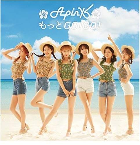 Apink group portrait on a beach, wearing hats and summer clothes.