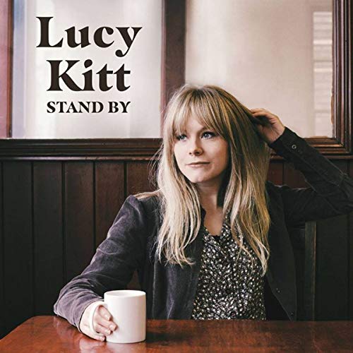 Lucy Kitt album cover featuring a woman with blonde hair and a mug.