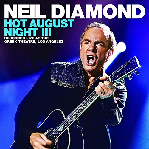 "Album cover featuring Neil Diamond singing and playing guitar under blue stage lighting."