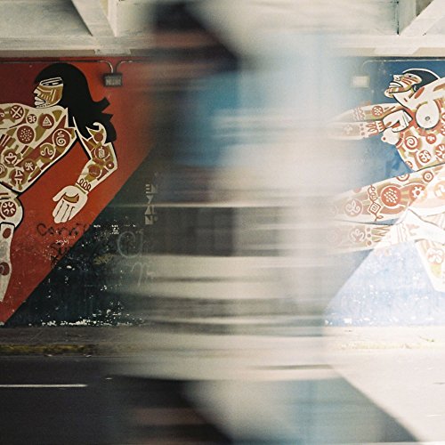 Blurred album cover with mural of figures and symbols.