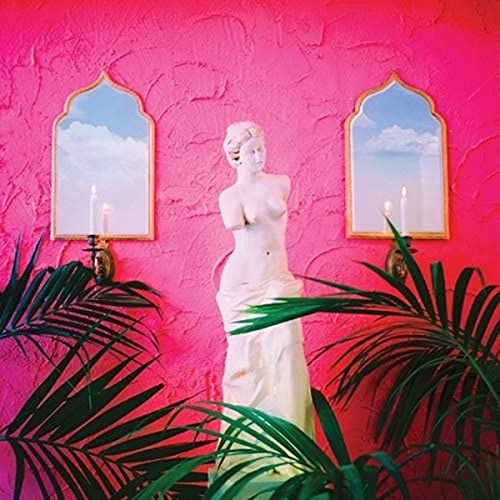 Pink textured wall with a white statue and framed mirrors.