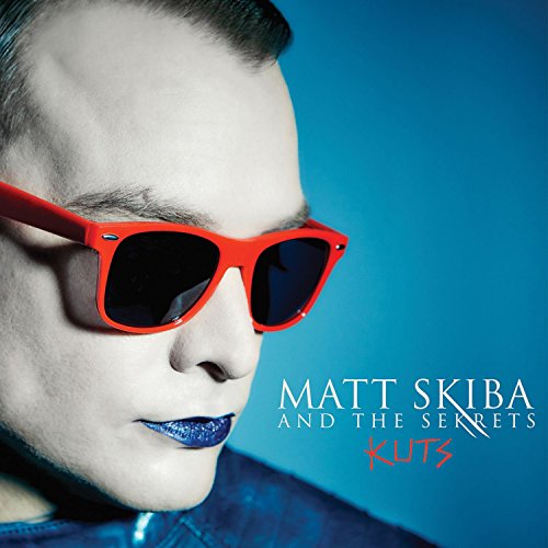 Album cover featuring a man wearing red sunglasses against a blue background.