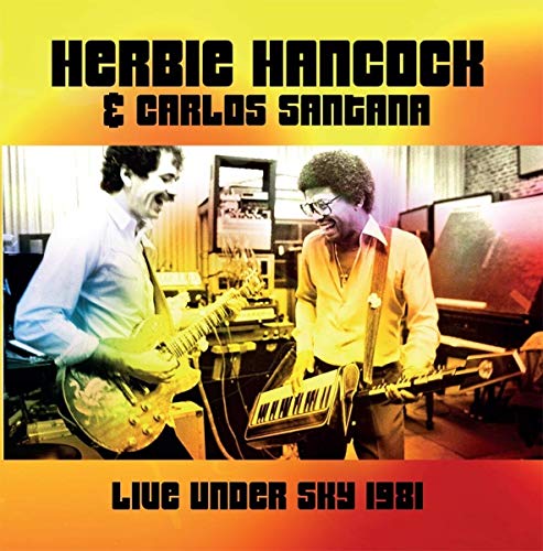 Herbie Hancock and Carlos Santana playing guitars in a studio, 1981.
