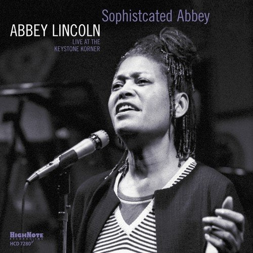 Black and white image of Abbey Lincoln singing into a microphone.