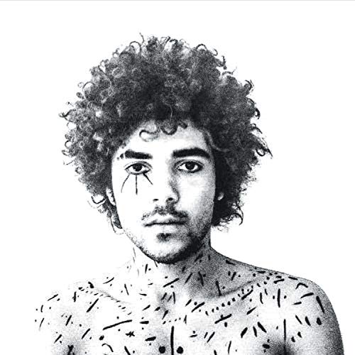 Black and white portrait of a man with curly hair and patterned skin.